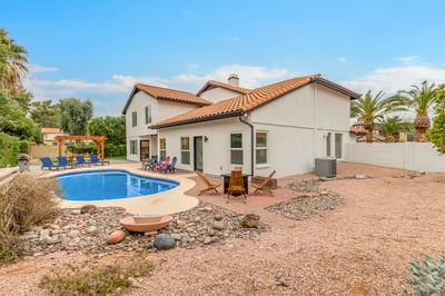 Large backyard retreat featuring a private pool, desert-inspired landscaping, multiple seating areas, and generous outdoor living space. A sought-after Scottsdale amenity package.