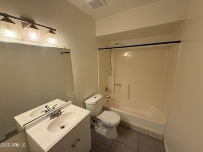 Full bathroom equipped with a modern vanity, updated lighting fixture, and tub-shower combination. Neutral finishes and practical design elements make this space ideal for everyday use.