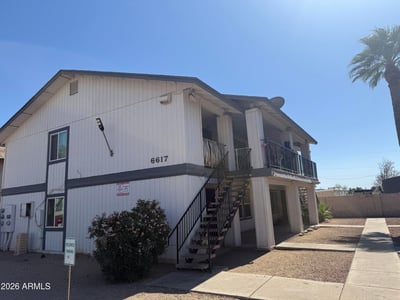 Inviting exterior perspective showcasing the property's well-kept grounds, designated parking, and mature landscaping. Residents enjoy a convenient Glendale location near dining, retail, and recreational opportunities.