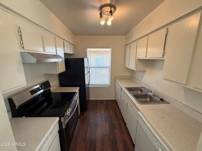 Functional galley-style kitchen featuring extensive cabinetry, generous counter space, and modern appliances. Designed for convenience, this space supports both everyday cooking and efficient organization.