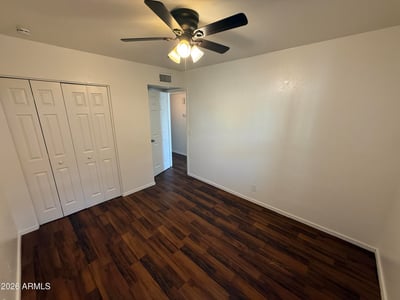 Well-sized bedroom with generous closet storage, ceiling fan, and attractive flooring. Ideal as a guest room, home office, or primary sleeping area within this Glendale apartment home.