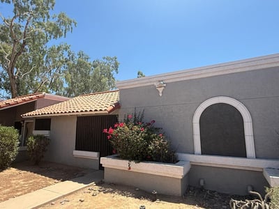 Exterior view highlighting classic Southwestern character, decorative architectural details, and mature landscaping. This appealing front elevation offers charm and easy upkeep for homeowners seeking convenience.