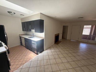 Spacious interior featuring an open living and kitchen design, abundant natural light, and durable tile flooring. The seamless layout creates a bright and inviting atmosphere perfect for modern living.
