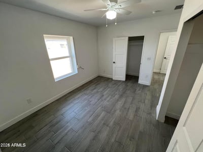 Designed for comfort and functionality, this bedroom showcases modern flooring, clean finishes, ample natural light, and convenient closet access. The flexible space easily adapts to a variety of living needs while complementing the home's updated interior.