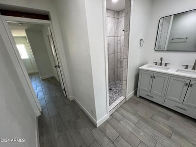 Beautiful tilework and a walk-in shower create a luxurious focal point in this remodeled bathroom. Updated cabinetry and modern finishes add both style and convenience for homeowners.
