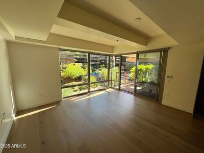 Inviting living space featuring large windows, patio access, and scenic courtyard views. The seamless connection to outdoor living enhances the home's resort-style atmosphere.