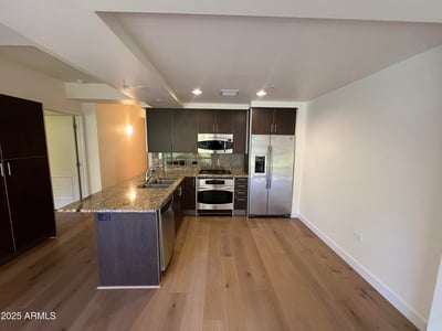 Well-appointed kitchen featuring granite counters, stainless steel appliances, rich cabinetry, and generous storage. A perfect setting for meal preparation and entertaining guests.
