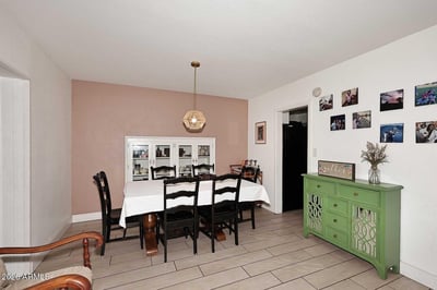 Host memorable dinners and family gatherings in this spacious dining room. The open layout, neutral color palette, and elegant lighting create an inviting atmosphere for any occasion.