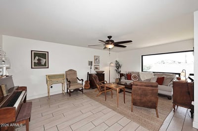 The main living room showcases abundant natural light, attractive flooring, and a spacious layout designed for comfort. Large windows create an airy feel while enhancing the home's open atmosphere.