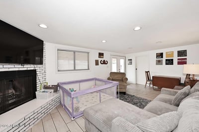 Gather around the cozy fireplace in this versatile family room featuring recessed lighting and direct backyard access. This comfortable space offers endless possibilities for recreation, relaxation, or entertaining.