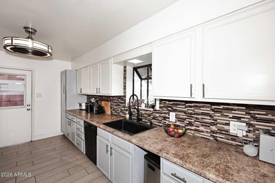 Attractive cabinetry, updated hardware, and ample counter space make this kitchen both beautiful and practical. The thoughtful design provides plenty of room for cooking, storage, and entertaining.