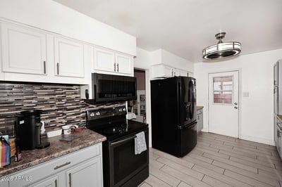 Abundant cabinetry, quality appliances, and attractive backsplash details highlight this inviting kitchen. The spacious design offers exceptional storage and workflow for daily living.