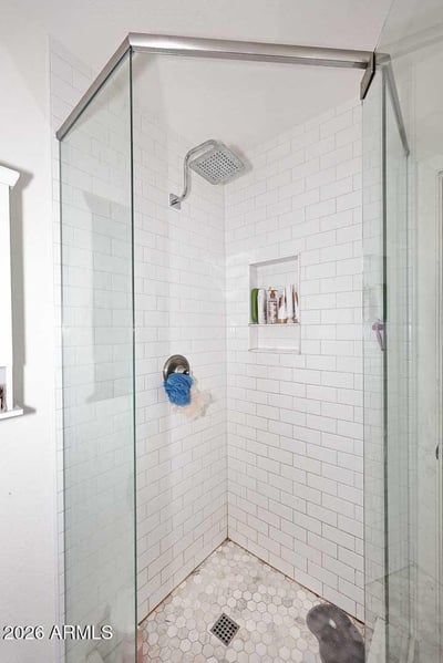 A spacious secondary bedroom with tile flooring, ceiling fan, and abundant natural light. The versatile floor plan easily accommodates guests, family members, or a home office setup.