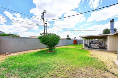 Featuring an expansive grassy yard and covered patio, this outdoor retreat offers exceptional space for entertaining, relaxing, and enjoying the Arizona climate. The private backyard extends the home's living and gathering spaces.