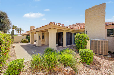 Beautiful backyard featuring mature desert landscaping, covered patio, and private outdoor living areas designed for easy maintenance and comfortable Scottsdale living.
