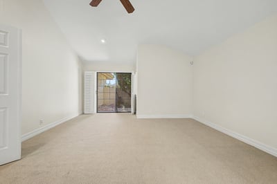 Bright and inviting primary bedroom with soaring ceilings, neutral d cor, updated finishes, generous floor space, and a relaxing atmosphere designed for everyday comfort.