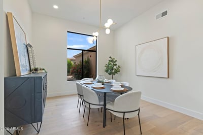 Sophisticated dining space with abundant natural light, stylish fixtures, and an open, airy feel. Designed to blend seamlessly with the home's modern layout while offering the perfect setting for gatherings.
