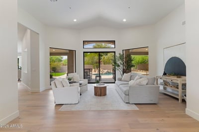 Beautiful great room overlooking the backyard through oversized windows and sliding glass doors. The seamless connection between indoor and outdoor living enhances the home's luxurious Scottsdale lifestyle.