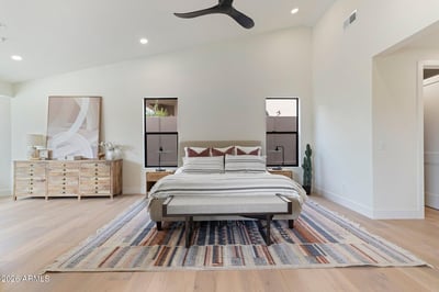 Elegant primary bedroom offering expansive living space, vaulted ceilings, oversized windows, and modern finishes. A peaceful retreat designed with style and functionality in mind.