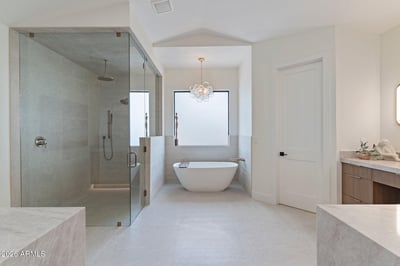 Beautifully designed primary bathroom with a freestanding soaking tub, expansive walk-in shower, custom cabinetry, and premium finishes. Spa-inspired luxury enhances everyday living.