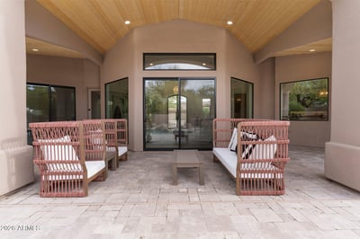 Spacious covered patio with wood-accent ceiling, comfortable seating, and direct access to the pool area. Ideal for enjoying Scottsdale's indoor-outdoor lifestyle.