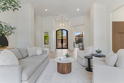 Spacious living room featuring high ceilings, abundant natural light, wide-plank flooring, and modern finishes. The open design creates a warm and comfortable setting for everyday living.