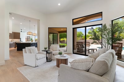 Comfortable living area with expansive backyard views, oversized glass doors, and abundant natural light. Designed for effortless entertaining and easy access to the outdoor living spaces.