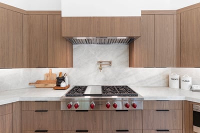 Professional-grade Wolf gas cooktop highlighted by sleek quartz countertops, custom cabinetry, designer backsplash, and premium finishes. A chef-inspired centerpiece for this beautifully remodeled Scottsdale home.