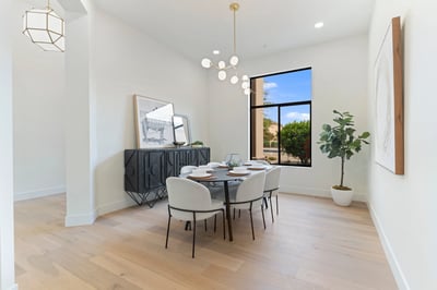 Elegant dining room showcasing modern lighting, oversized windows, and refined finishes that complement the home's contemporary design. A welcoming space for memorable dinners and entertaining in this luxury Scottsdale residence.