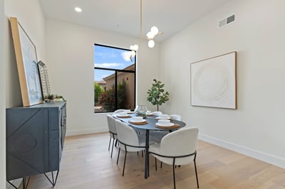 Sophisticated dining space with abundant natural light, stylish fixtures, and an open, airy feel. Designed to blend seamlessly with the home's modern layout while offering the perfect setting for gatherings.