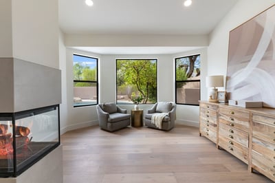 Relaxing lounge area with backyard views, large picture windows, and a contemporary fireplace. This inviting extension of the primary suite offers both elegance and versatility.