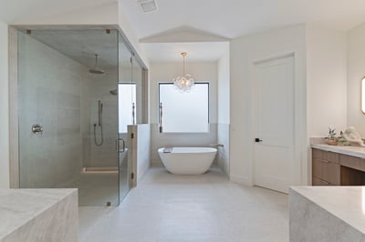 Beautifully designed primary bathroom with a freestanding soaking tub, expansive walk-in shower, custom cabinetry, and premium finishes. Spa-inspired luxury enhances everyday living.