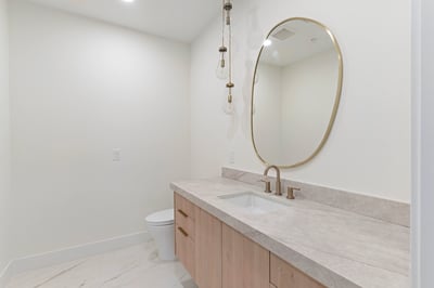 Elegant guest bathroom with quartz counters, custom cabinetry, designer lighting, and upscale hardware. Every detail reflects the exceptional craftsmanship found throughout this Scottsdale residence.