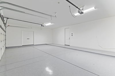 Clean, oversized garage featuring durable epoxy flooring, generous storage space, and room for multiple vehicles. A practical upgrade that enhances everyday living in this Scottsdale property.