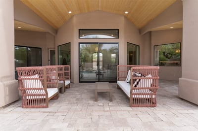 Spacious covered patio with wood-accent ceiling, comfortable seating, and direct access to the pool area. Ideal for enjoying Scottsdale's indoor-outdoor lifestyle.