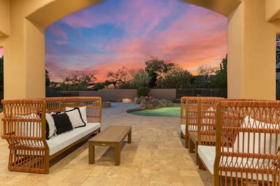 Relax beneath the covered patio while enjoying colorful Scottsdale sunsets overlooking the sparkling pool, fire feature, and beautifully landscaped backyard retreat.