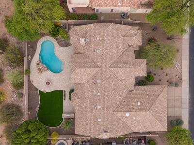 Overhead aerial displaying the home's impressive footprint, private backyard retreat, resort-style pool, entertaining patio, and professionally landscaped outdoor spaces in Scottsdale.