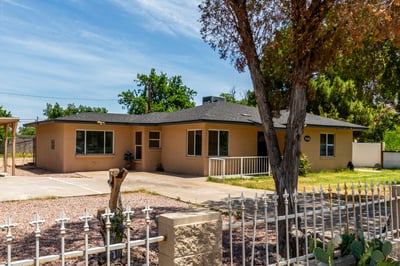 Enjoy the attractive front exterior featuring mature shade trees, a grassy yard, durable construction, and fenced outdoor space. This Mesa home offers room to grow while maintaining easy access to shopping, dining, and entertainment.