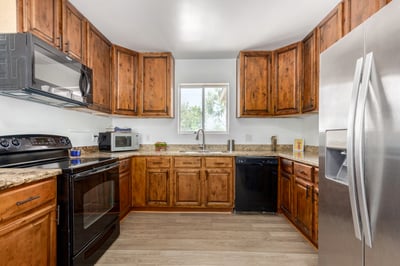 The remodeled kitchen offers extensive cabinet storage, granite countertops, built-in appliances, and a bright, efficient layout. Designed for both style and practicality, it serves as the centerpiece of this Mesa home.