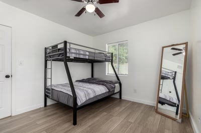 Spacious secondary bedroom featuring updated finishes, large windows, and flexible layout options for sleeping, studying, or working from home in this Mesa residence.