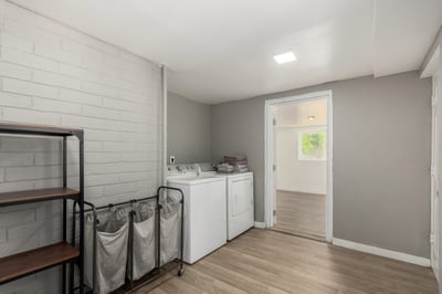 Spacious laundry and utility room with durable flooring, washer and dryer hookups, and room for storage or organization. Designed to simplify daily routines while adding practical functionality to this Mesa property.
