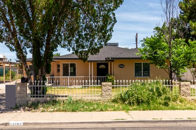 The front elevation welcomes you with mature trees, a fenced yard, covered porch, and updated exterior finishes. This Mesa home offers move-in-ready appeal, spacious outdoor living, and exceptional flexibility without HOA restrictions.