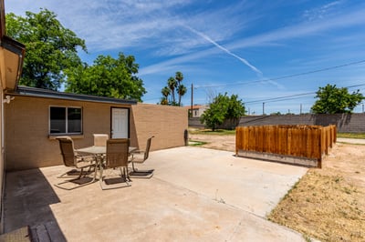 Inviting backyard patio with plenty of room for outdoor dining and gatherings. Surrounded by a spacious yard, this outdoor living area offers endless possibilities for enjoying Arizona's beautiful weather in Mesa.