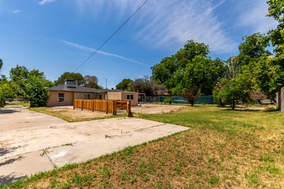 Expansive backyard featuring mature shade trees, generous lawn areas, and ample space for recreation, gardening, or future outdoor improvements. A standout feature of this Mesa property.