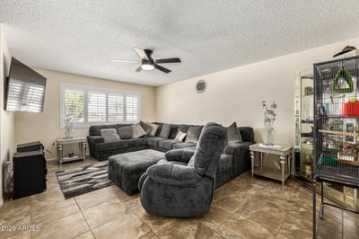 Bright great room offering plenty of seating space, tile flooring, natural light, and a welcoming atmosphere that connects beautifully with the rest of the home.