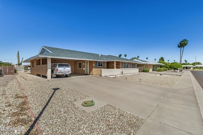 Spacious driveway and covered golf cart parking provide convenient parking and easy access while complementing the home's low-maintenance exterior.