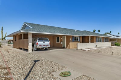 Covered carport, spacious driveway, and welcoming front entrance create everyday convenience. The well-maintained exterior complements the home's updated features and attractive Sun City location.