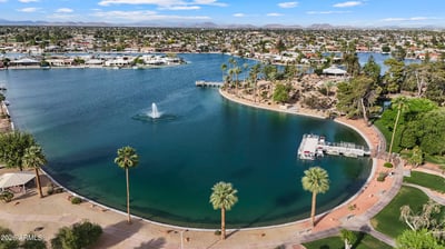 Scenic aerial captures the nearby lake, walking trails, landscaped shoreline, and relaxing outdoor spaces that make Sun City an enjoyable place to call home.