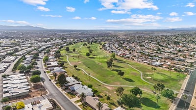 Elevated aerial showcases lush fairways, winding golf cart paths, mature trees, and beautifully maintained open spaces. Sun City offers a picturesque golf-oriented setting with abundant recreation.