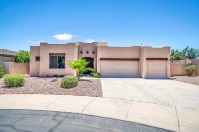 Attractive front elevation featuring classic Southwest architecture, desert landscaping, and an inviting entryway. This Palm Valley home in Goodyear offers exceptional curb appeal, seller-owned solar, and a spacious 3-car garage.